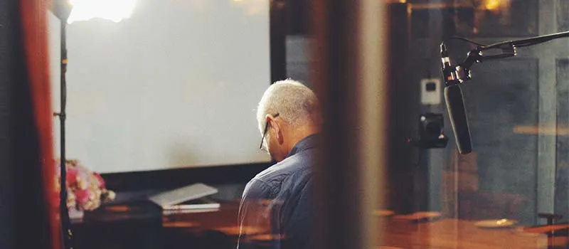 man working in a recording studio on a podcast