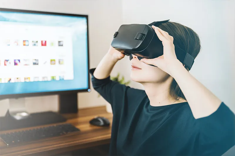 technology in the workplace: a woman using virtual reality in the workplace