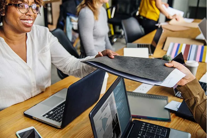 A woman is smiling during her office meeting