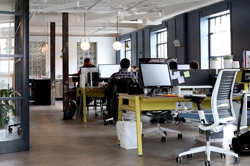 modern office with a team working on their desktops