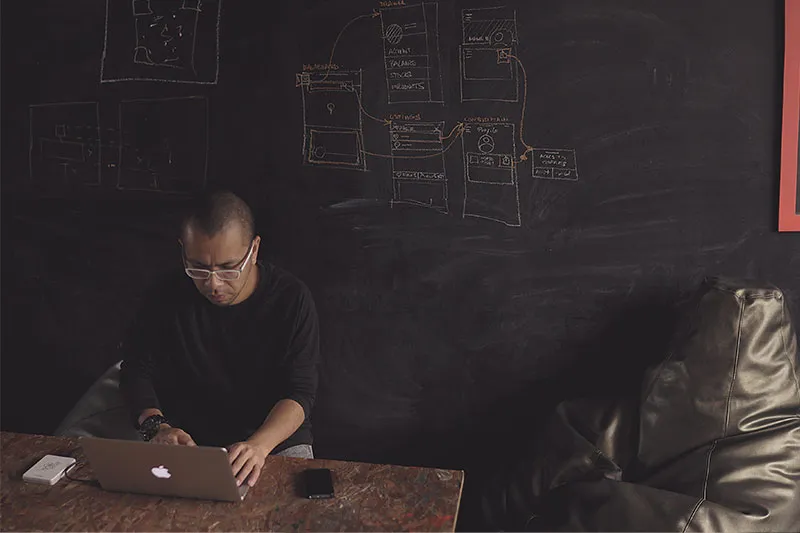 a man working on his laptop in a meeting room