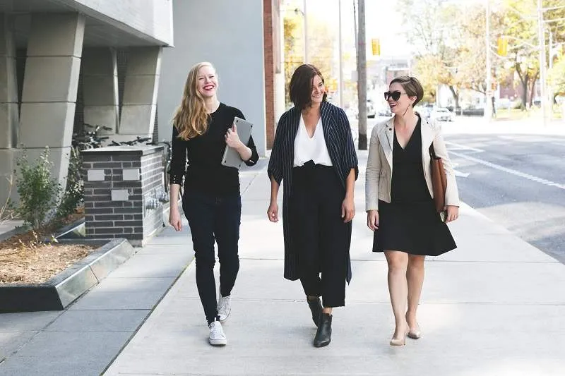 three women walking down the street