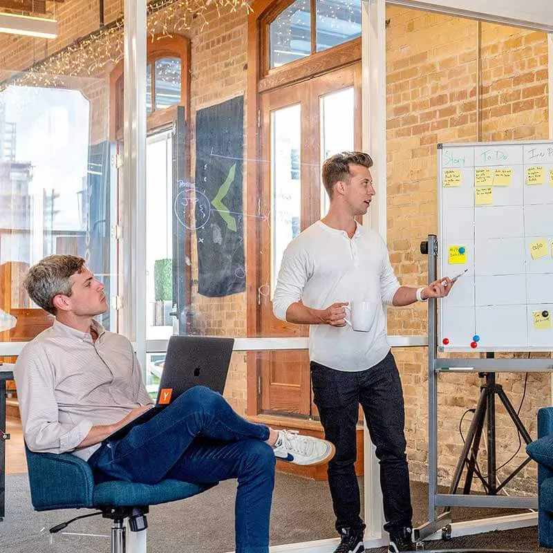 man presenting content from a whiteboard