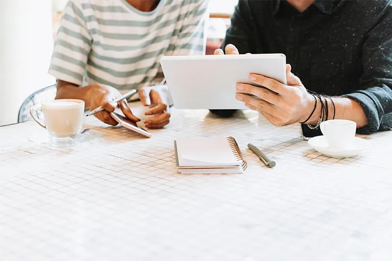 two coworkers working on a tablet