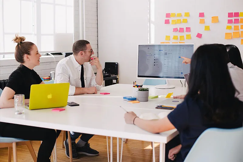 employees participating in a change management processes meeting looking at a presentation on screen