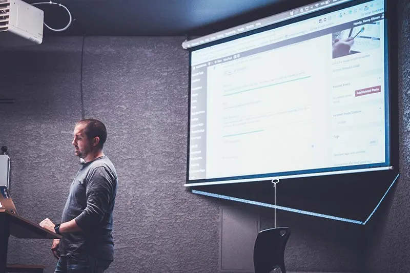 man giving a presentation using a projector