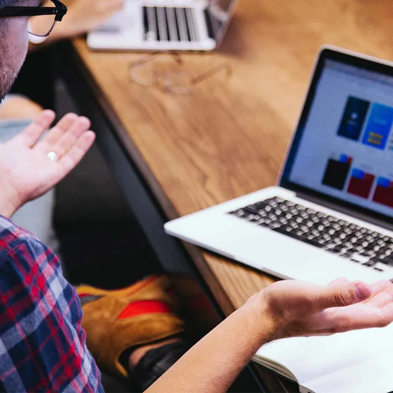 man trying to figure out a software application on his laptop