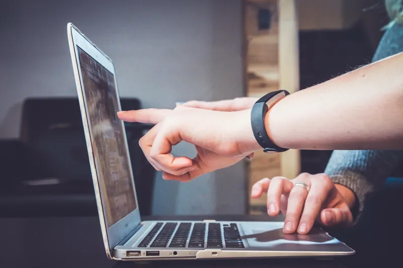 training manager and employee working on a laptop