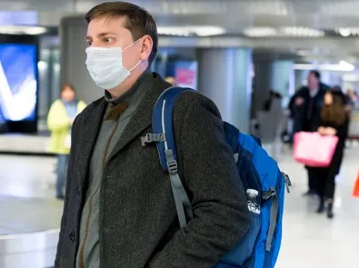 man wearing face mask at airport