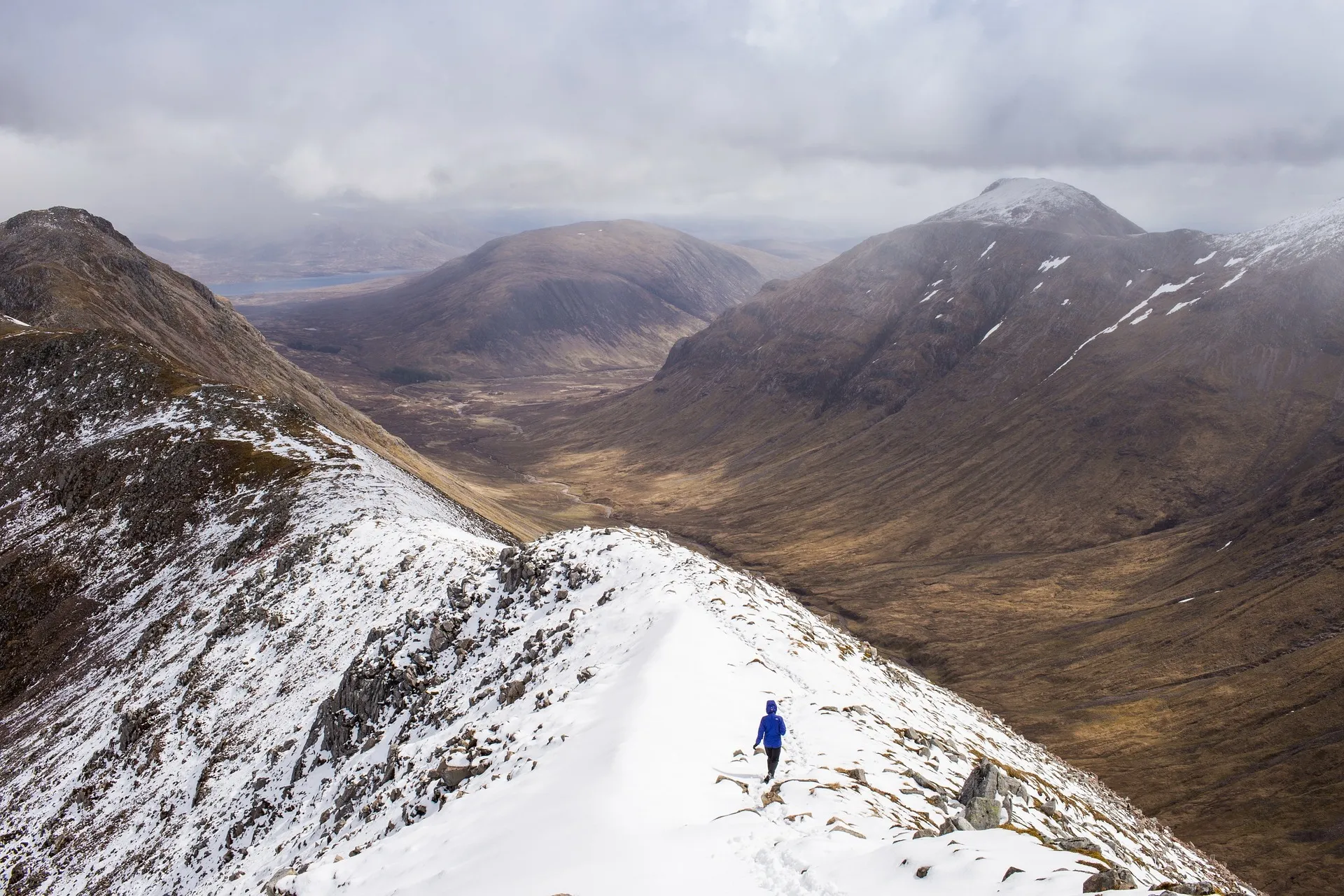 a man walking on a mountain range