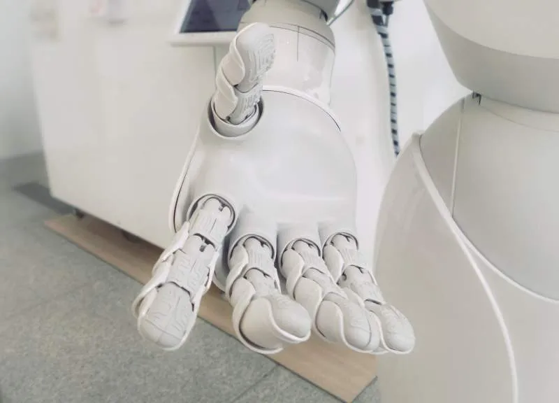 hand of robot demonstrating AI and innovation