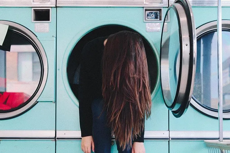 girl sitting inside a washing machine