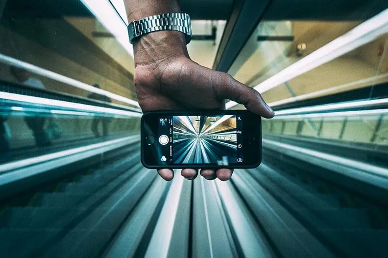 a man taking pictures in an elevator