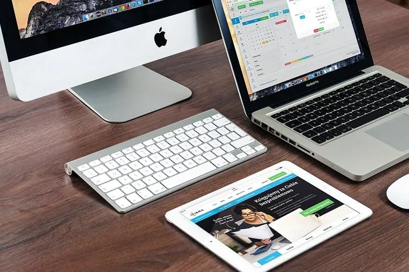 apple macbook pro on a wooden table