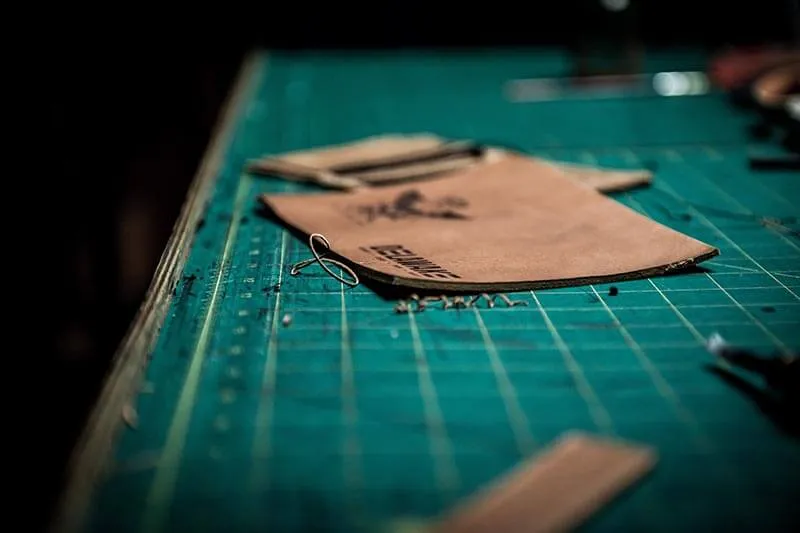 pieces of leather on a green table in a black background