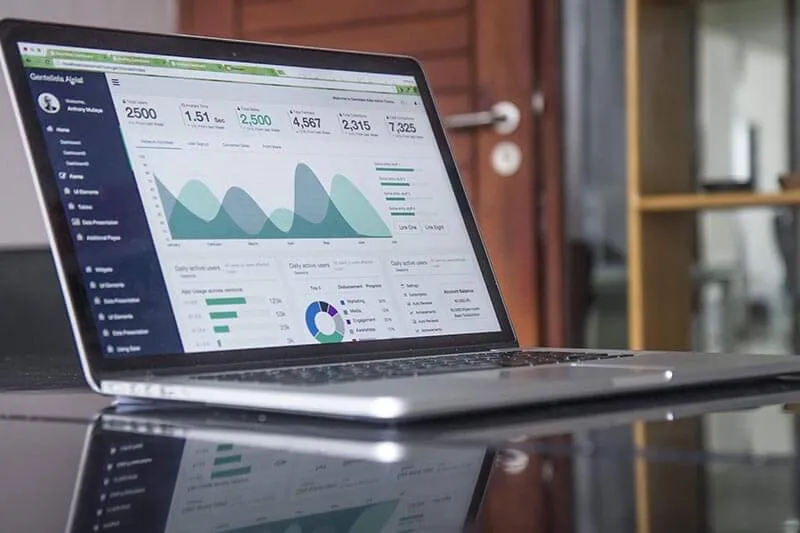 laptop on table displaying customer success analytics to track user activation 