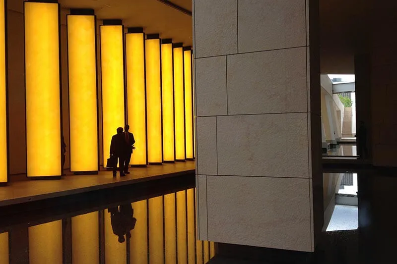 two people walking down a corridor