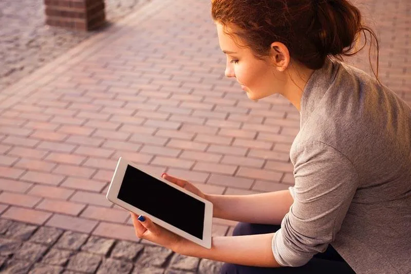 a girl reading a document on her tablet