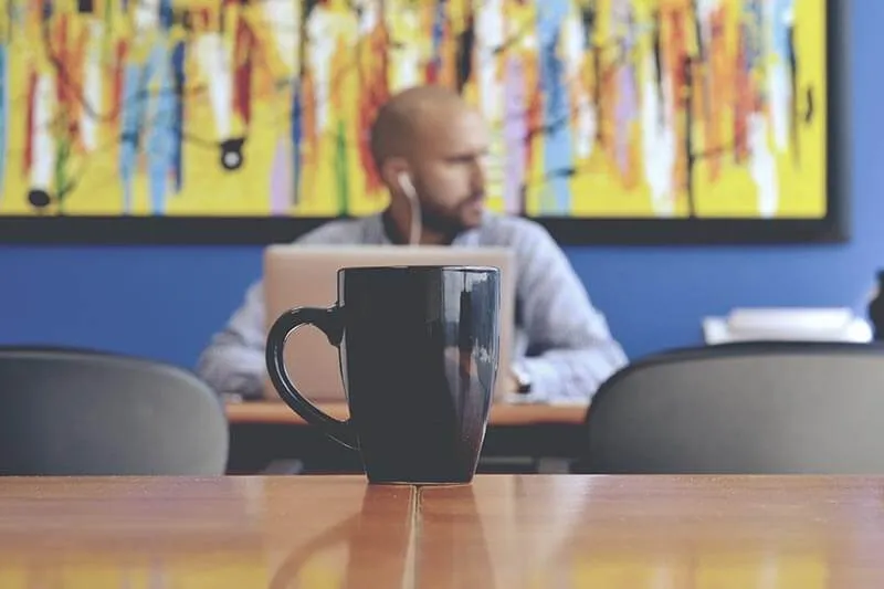 a coffee cup and a customer listening to music