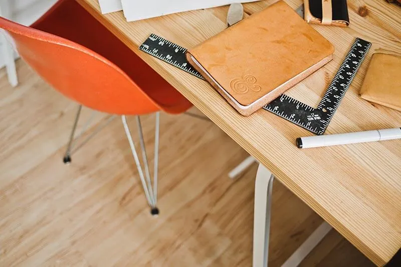 books, pen and a ruler on a table