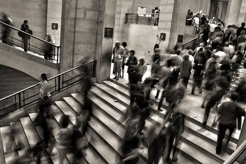 a group of people walking inside a building