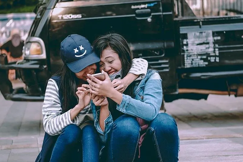 happy customer checking emails on a mobile device