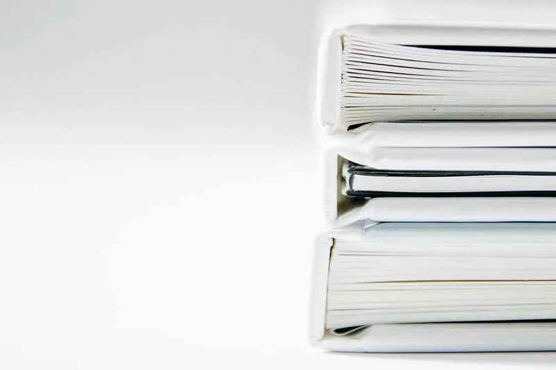 white books placed on a white table