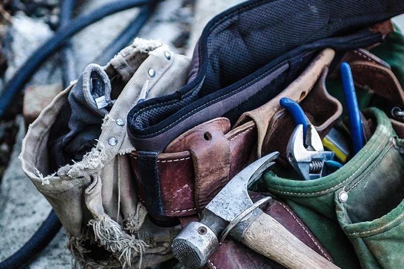 hammer and tools in a leather tool-belt