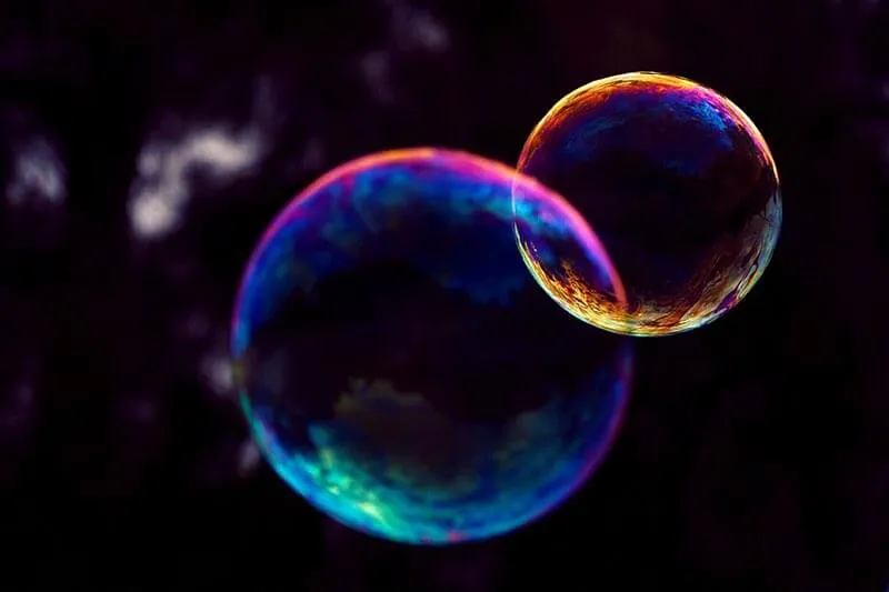 two soap bubbles in a dark background