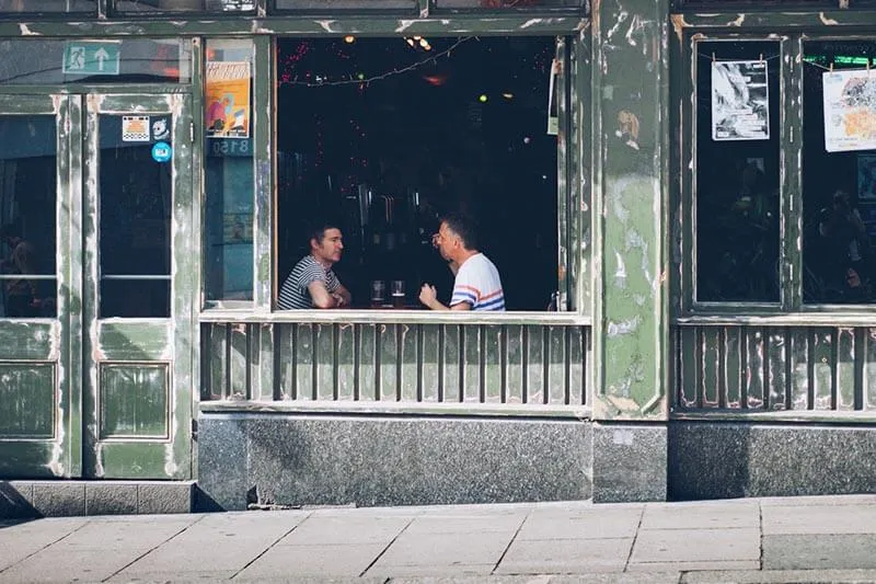 two happy customers talking in an old coffee shop