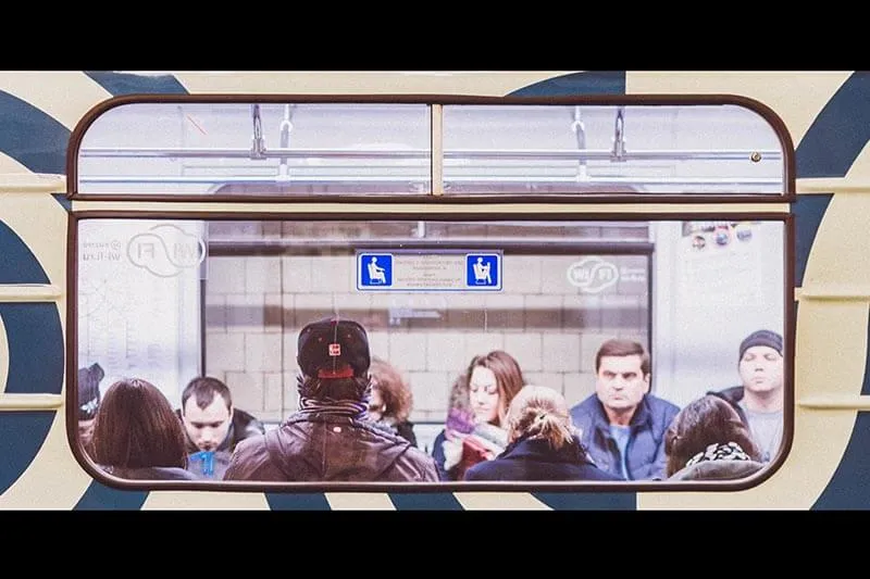 group of people sitting inside a subway train car