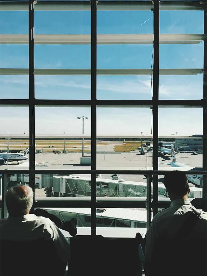 view of parked planes from the airport passenger's lounge