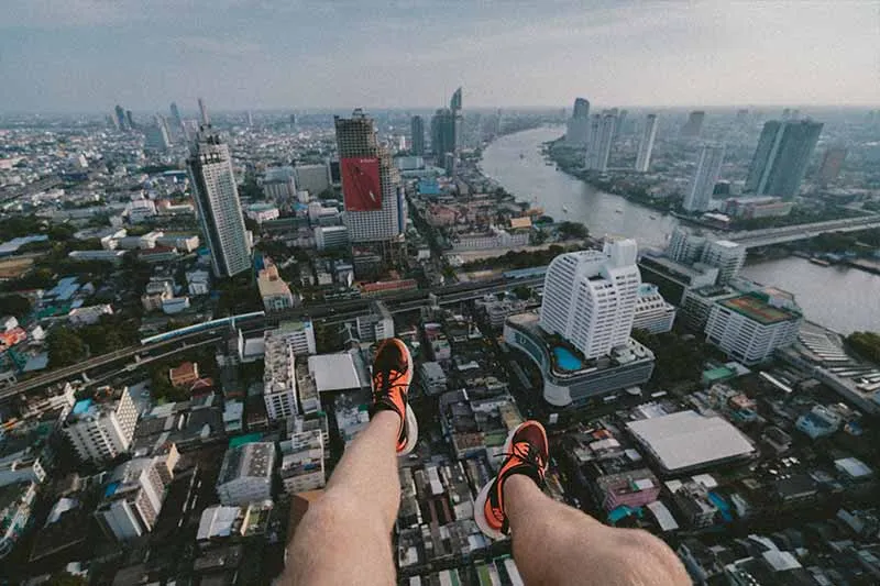 a person sitting on the edge of the building