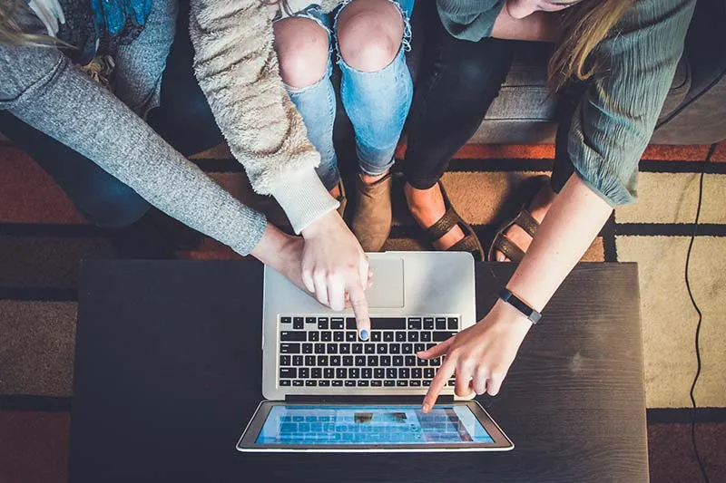 customer success team working on an Apple Macbook