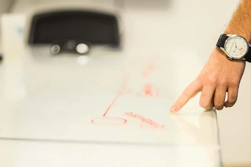 a man pointing his finger to a chart on a table