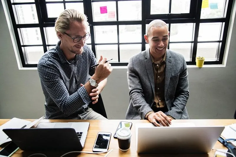 two men reviewing a project plan