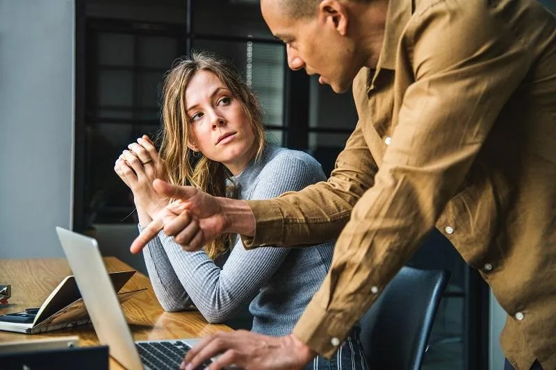 man and woman working together in conference room