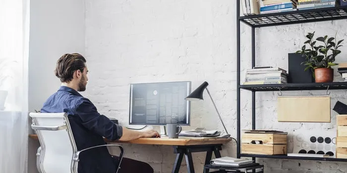 young professional man at desk working on computer